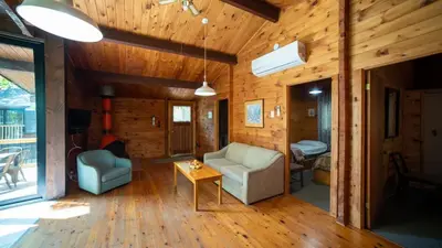 a living room with two chairs and a table at Lake Muskoka 3-bdrm Cottage - Pier 100 #70 in Port Carling