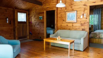 a living room with a couch and a table at Lake Muskoka 3-bdrm Cottage - Pier 100 #70 in Port Carling