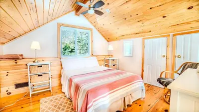 a bedroom with a bed and a ceiling fan at Muskoka Lakefront 3-bdrm Chalet #90 in Port Carling