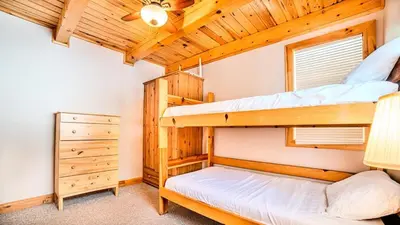 a bedroom with two bunk beds in a cabin at Muskoka Lakefront 3-bdrm Chalet #90 in Port Carling