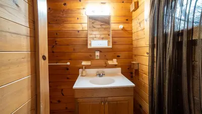 a bathroom with a sink and a mirror at Muskoka Lakeview Cottage - Pier 100 #40 in Port Carling