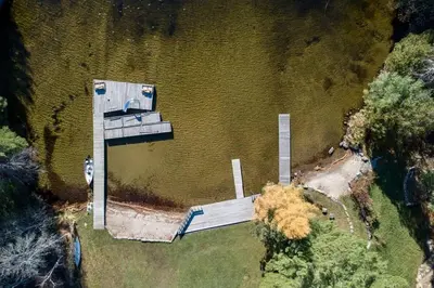 an aerial view of a dock in the middle of a lake at Lake Muskoka Deluxe 2-bdrm Cottage - Pier 100 #60 in Port Carling