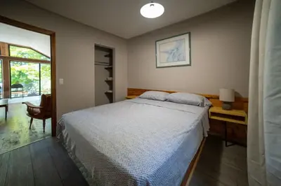 a bedroom with a bed and a desk and a window at Lake Muskoka Deluxe 2-bdrm Cottage - Pier 100 #60 in Port Carling
