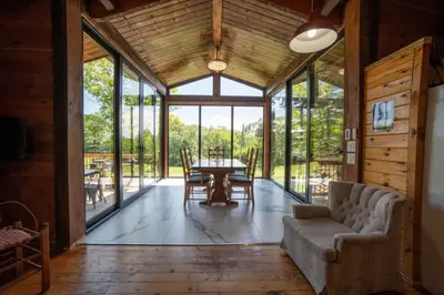a living room with a couch and a table at Lake Muskoka 3-bedroom Cottage - Pier 100 #20 in Port Carling