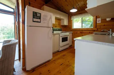 a kitchen with a white refrigerator and a stove at Lake Muskoka 3-bedroom Cottage - Pier 100 #20 in Port Carling
