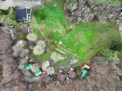 an aerial view of a yard with a house at Lake Muskoka 3-bedroom Cottage - Pier 100 #20 in Port Carling
