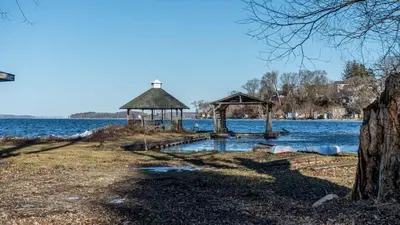 a dock with a gazebo in the middle of a lake at 2-bedroom Lake Front Cottage in Harwood ON #6 in Harwood
