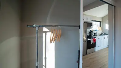 a kitchen with a sliding glass door in a room at 2-bedroom Lake Front Cottage in Harwood ON #4 in Harwood
