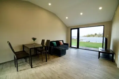 a living room with a table and chairs and a couch at 1-bedroom Townhouse in Harwood #3 in Harwood