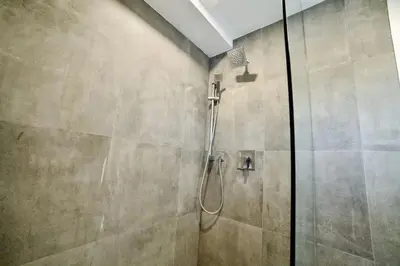 a shower with a glass door in a bathroom at 1-bedroom Townhouse in Harwood #3 in Harwood