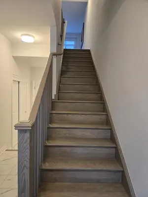 a staircase in a house with wooden floors at Modern 4 Bedroom Home -Oakville in Oakville