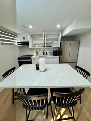 a kitchen with a table and chairs in a room at 2 BR Private Basement Suite | Minutes from YYZ in Brampton