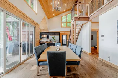 a dining room with a table and chairs at Lakefront cottage with golf area BBQ pool table in Bobcaygeon