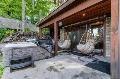 a patio with two chairs and a bath tub at Lakefront cottage with golf area BBQ pool table in Bobcaygeon