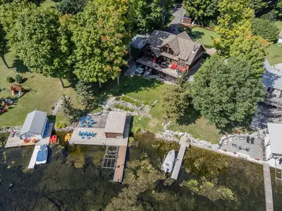 an overhead view of a large house with a yard at Lakefront cottage with golf area BBQ pool table in Bobcaygeon
