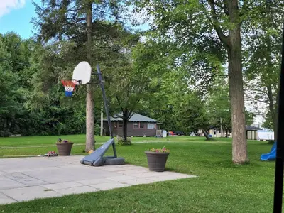 a basketball hoop in a park with a playground at Balsam Lake - 2-Bedroom Cottage #8 in Kawartha Lakes