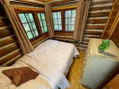 a bedroom with two beds in a log cabin at 2-Bedroom - Balsam Lake Cottages Resort #12 in Kawartha Lakes