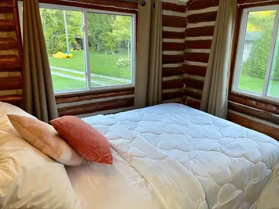 a white bed in a room with a window at Balsam Lake - 2-Bedroom Cottage #6 in Kawartha Lakes
