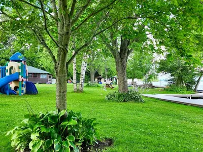 a park with a playground with trees and a play park at Balsam Lake - 2-Bedroom House in Kawartha #15 in Kawartha Lakes