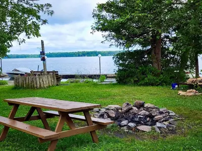a picnic table sitting next to a pile of rocks at Balsam Lake - 2-Bedroom House in Kawartha #15 in Kawartha Lakes
