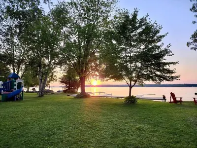 a park with trees and benches and the water at Balsam Lake - 2-Bedroom House in Kawartha #15 in Kawartha Lakes