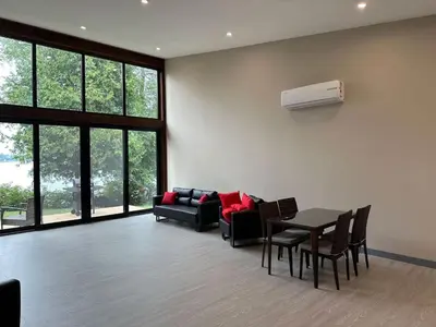 a living room with a couch and a table and chairs at 3-bedroom Lakefront Villa #7 in Lakefield