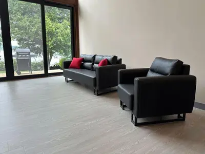 a waiting room with two couches and red pillows at 3-bedroom Lakefront Villa #7 in Lakefield