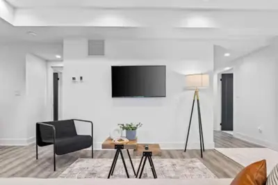 a living room with a black chair and a table at RentX Cozy Downtown London Parking WiFi in London