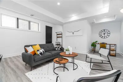 a living room with a couch and a table at RentX Cozy Downtown London Parking WiFi in London