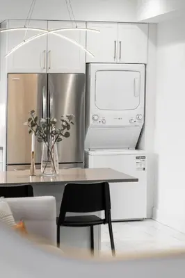 a kitchen with a table with a microwave and a refrigerator at RentX Cozy Downtown London Parking WiFi in London
