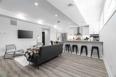 a living room with a couch and a kitchen at RentX Cozy Downtown London Parking WiFi in London
