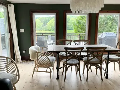 a dining room with a table and chairs at Muskoka Cabana - Sandy beach cottage in Muskoka in Utterson