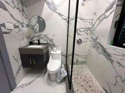 a bathroom with a shower and a toilet and a sink at 3-bedroom Villa in Lakefield #17 in Lakefield