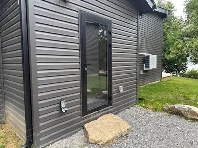 a black house with a door and a window at 3-bedroom Villa in Lakefield #17 in Lakefield