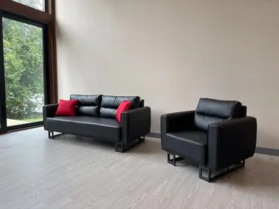 two black chairs and a couch in a room at 3-bedroom Villa in Lakefield #11 in Lakefield