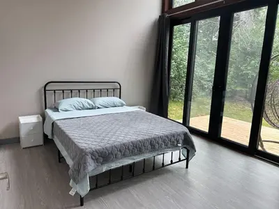 a bedroom with a bed and a large window at 3-bedroom Villa in Lakefield #11 in Lakefield