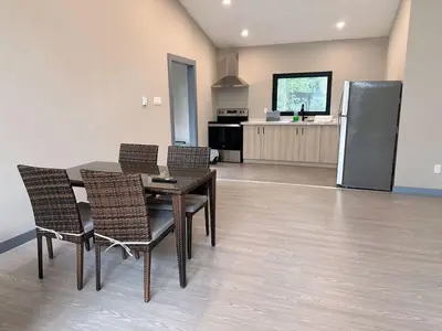 a dining room with a table and chairs and a kitchen at 3-bedroom Villa in Lakefield #11 in Lakefield