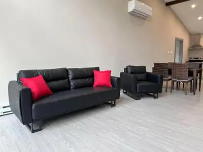a black couch with red pillows in a living room at 3-bedroom Villa in Lakefield #11 in Lakefield