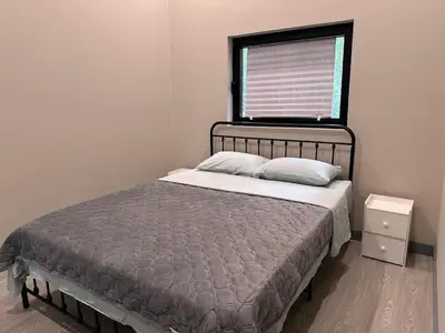 a bed in a room with a window and a bed sidx sidx sidx at 3-bedroom Lakefront Villa #10 in Lakefield