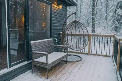 a rocking chair on a porch in the snow at 3-bedroom Villa in Lakefield #15 in Lakefield