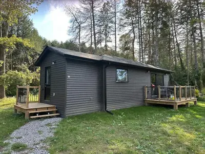 a small cabin with a porch and a deck at 3-bedroom Villa in Lakefield #15 in Lakefield