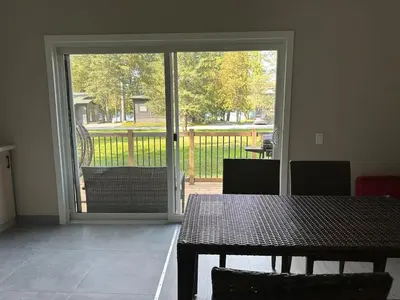 a dining room with a table and a sliding glass door at 3-bedroom Villa in Lakefield #15 in Lakefield