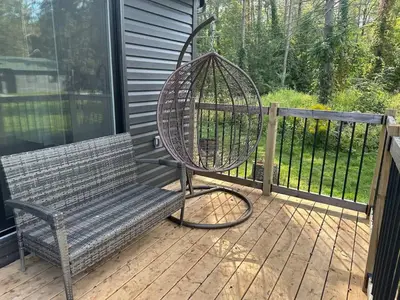 a bench on a porch with a bird cage at 3-bedroom Villa in Lakefield #15 in Lakefield