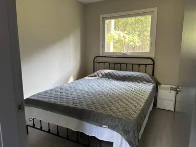 a small bedroom with a bed and a window at 3-bedroom Villa in Lakefield #15 in Lakefield