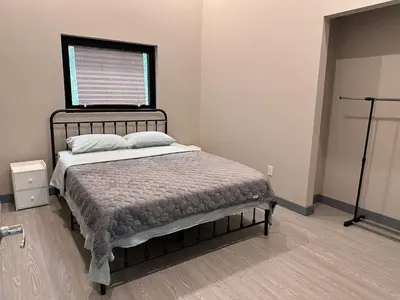 a bed in a room with a window and a bed sidx sidx sidx at 3-bedroom Lakefront Villa #2 in Lakefield