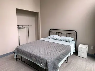 a bedroom with a bed with a metal frame at 3-bedroom Lakefront Villa #2 in Lakefield