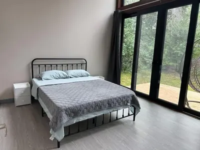 a bedroom with a bed in a room with windows at 3-bedroom Lakefront Villa #2 in Lakefield