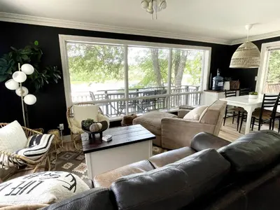 a living room with a couch and a table at The Muskoka Nest in Utterson