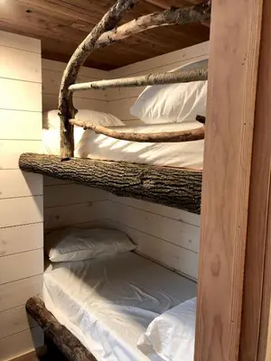 a couple of bunk beds in a cabin at The Water’s Edge * * Unique Muskoka Treehouse * * in Utterson