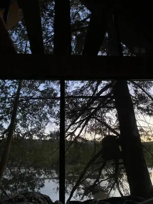 a view of a lake from a window at The Water’s Edge * * Unique Muskoka Treehouse * * in Utterson